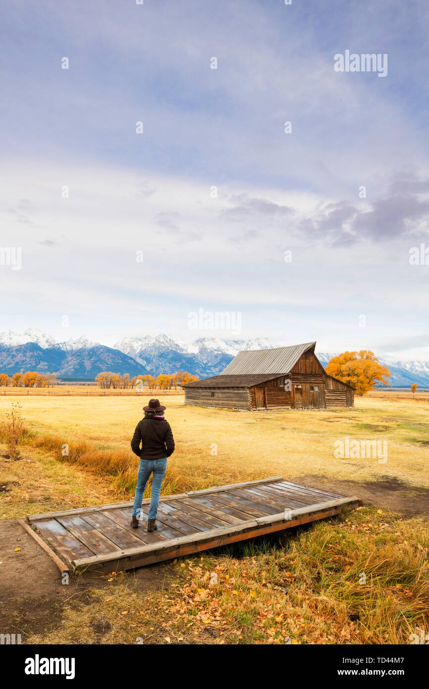 Woman at Mormon Row and Teton Range, Grand Teton National Park, Wyoming, United States of America, North America Stock Photo