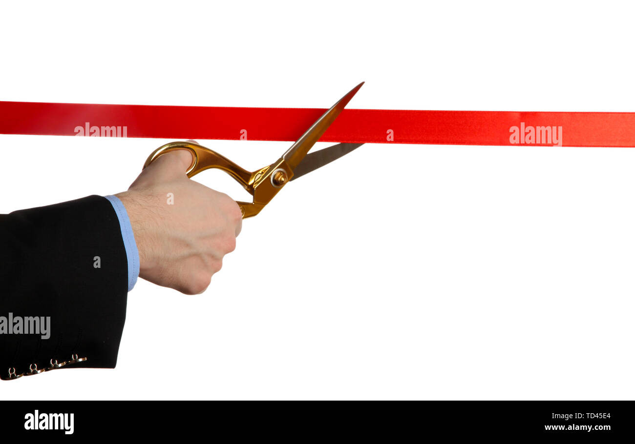 Man's hand cutting red ribbon with pair of scissors isolated on white Stock Photo