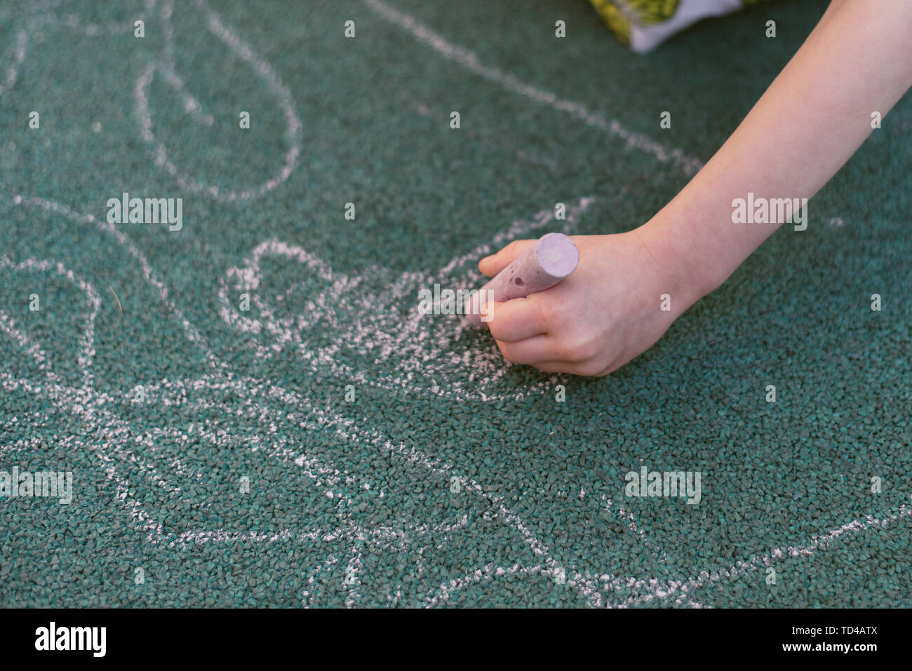 A child has used drawing chaulk to creat art on a playground Stock Photo -  Alamy