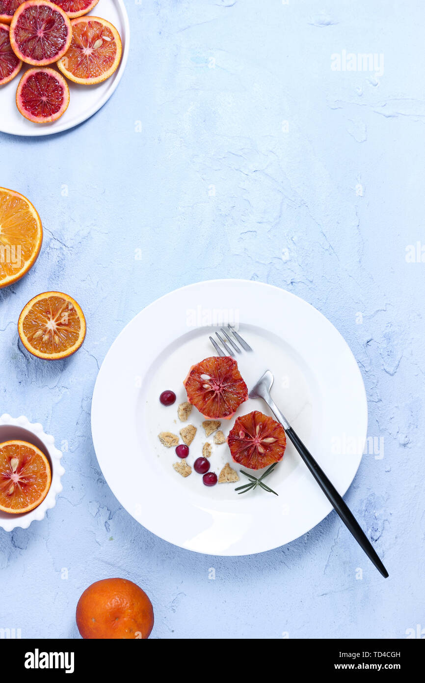 One man eating yogurt fruit cereal breakfast on blue background Stock Photo