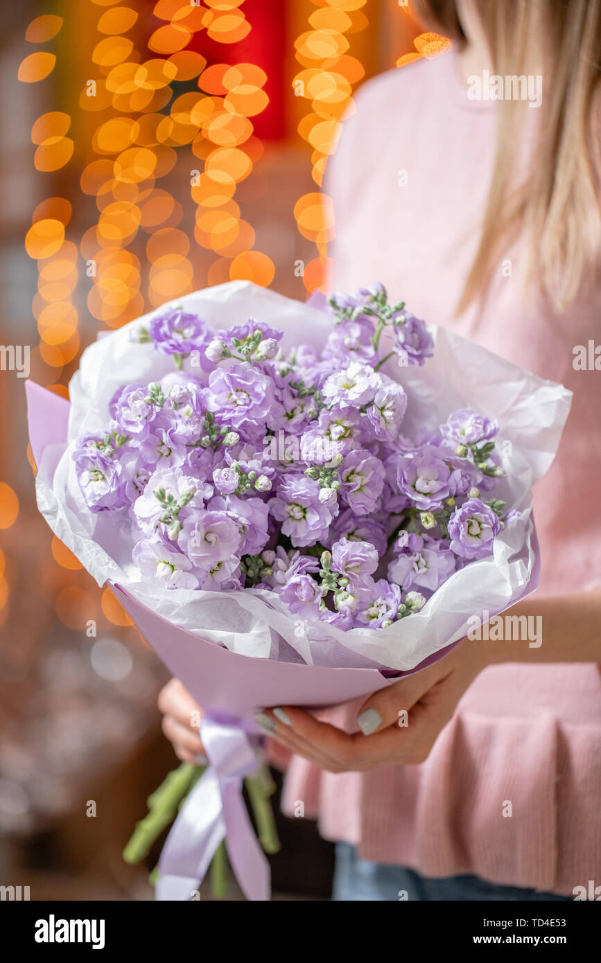 Beautiful Bouquet Of Lilac Flowers In Woman Hand Floral Shop Concept Beautiful Fresh Cut Bouquet Flowers Delivery Bokeh Of Garland Lights On Stock Photo Alamy