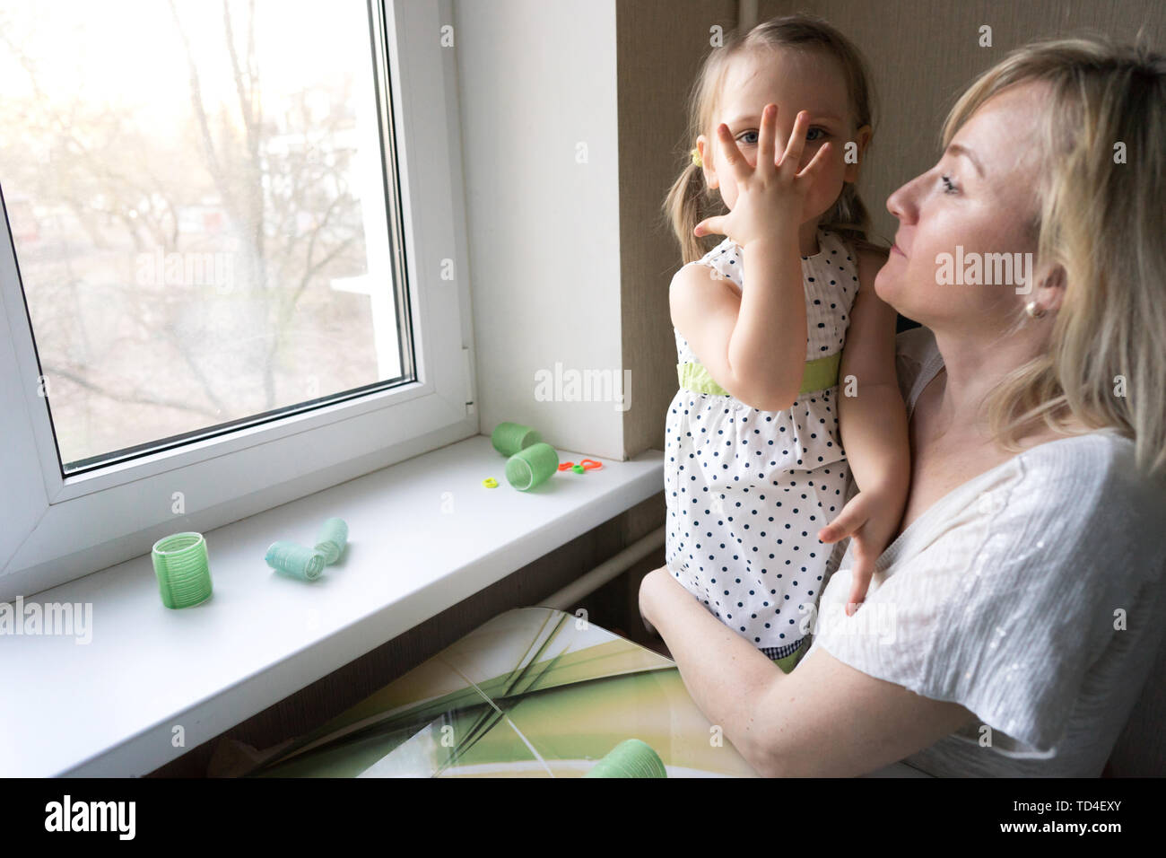 Mom And Daughter Sitting At The Window Stock Photo Alamy