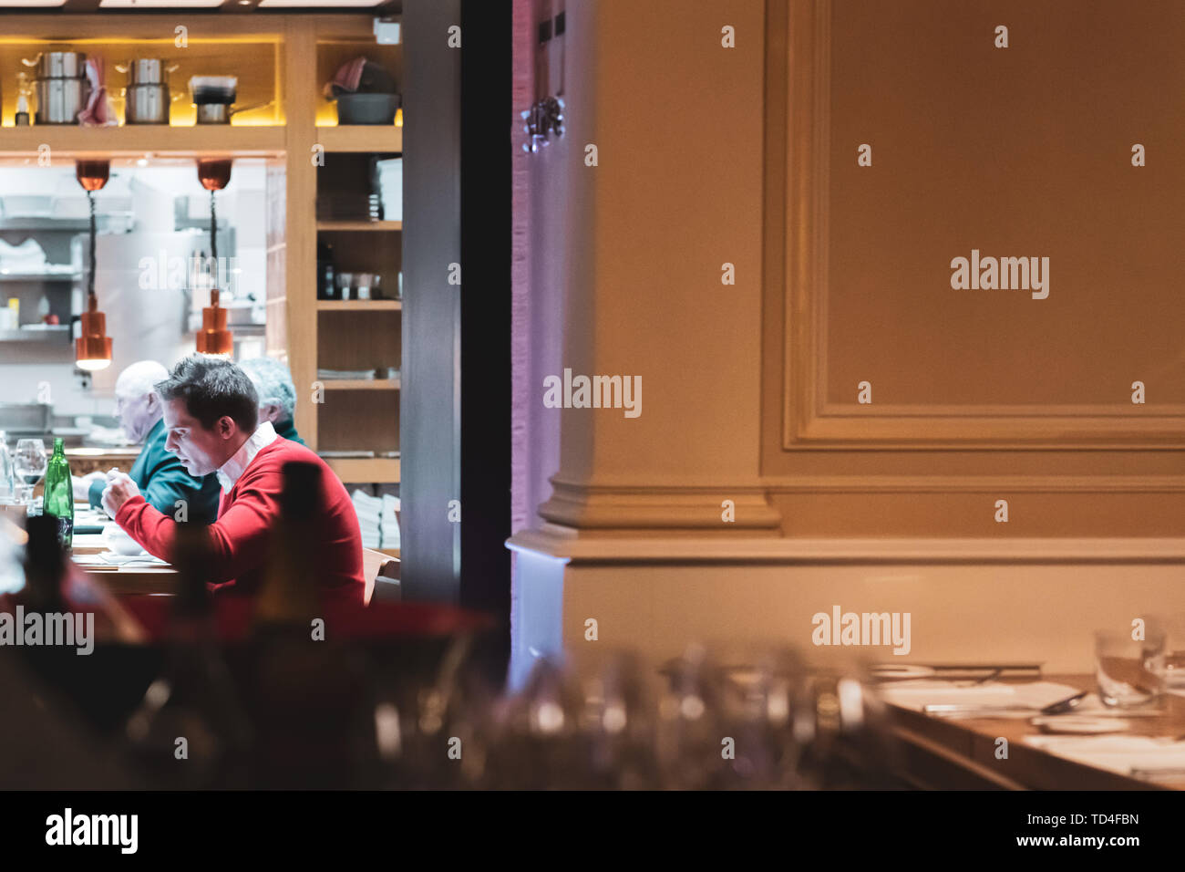 PRAGUE, CZECH - 12TH APRIL 2019: A man sits inside a restaurant eating in Next Door by Imperial, one of the captials upmarket restaurants Stock Photo