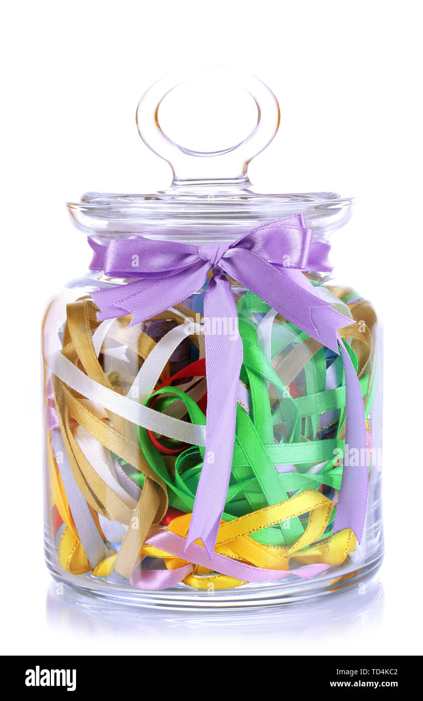 Glass jar containing various colored ribbons isolated on white Stock ...
