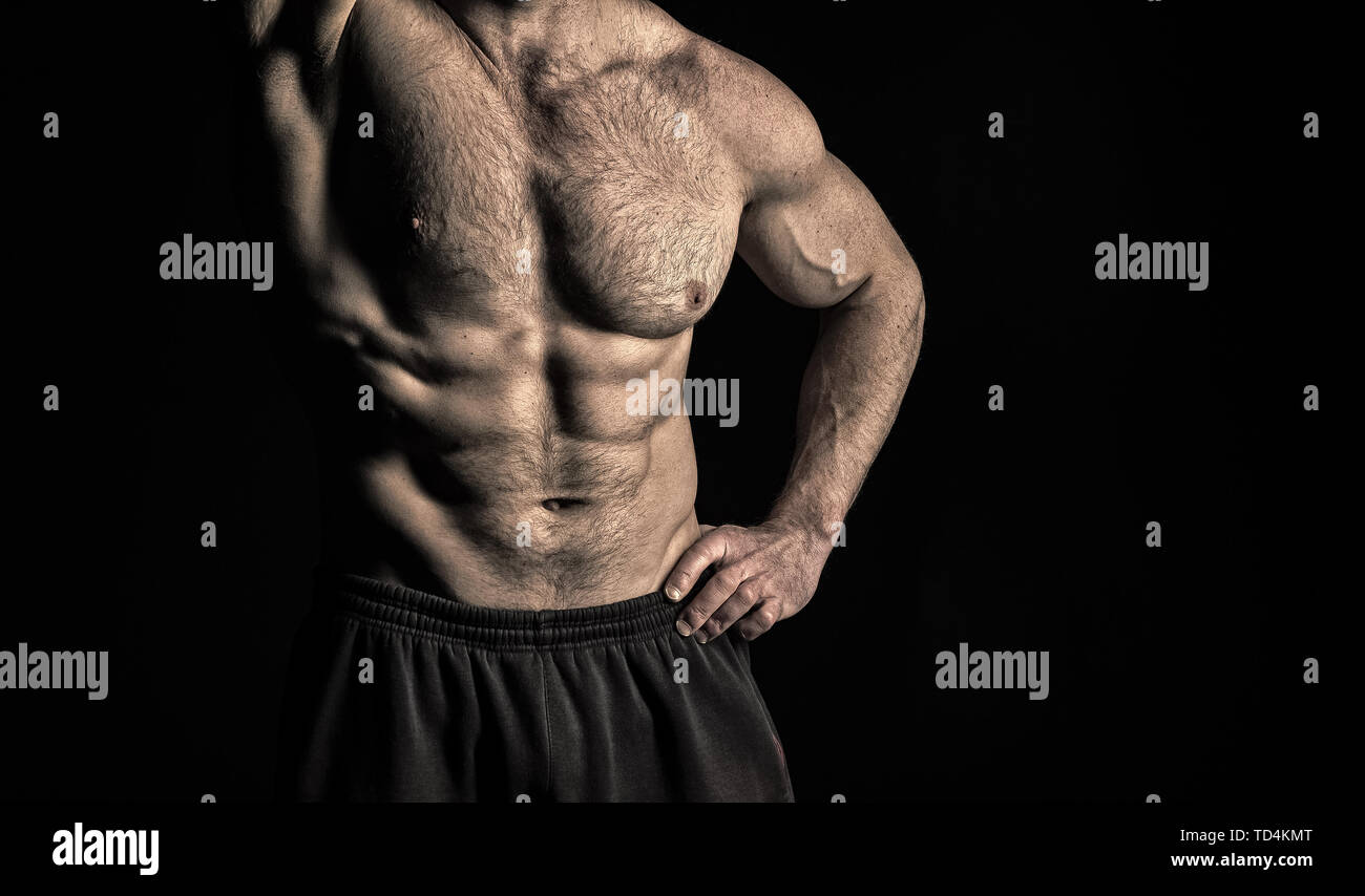 Arm with strong biceps and triceps. Torso with six pack and ab muscles.  Athletic belly and muscular chest. Workout and training activity in gym.  Sport fitness and wellness concept, vintage Stock Photo 