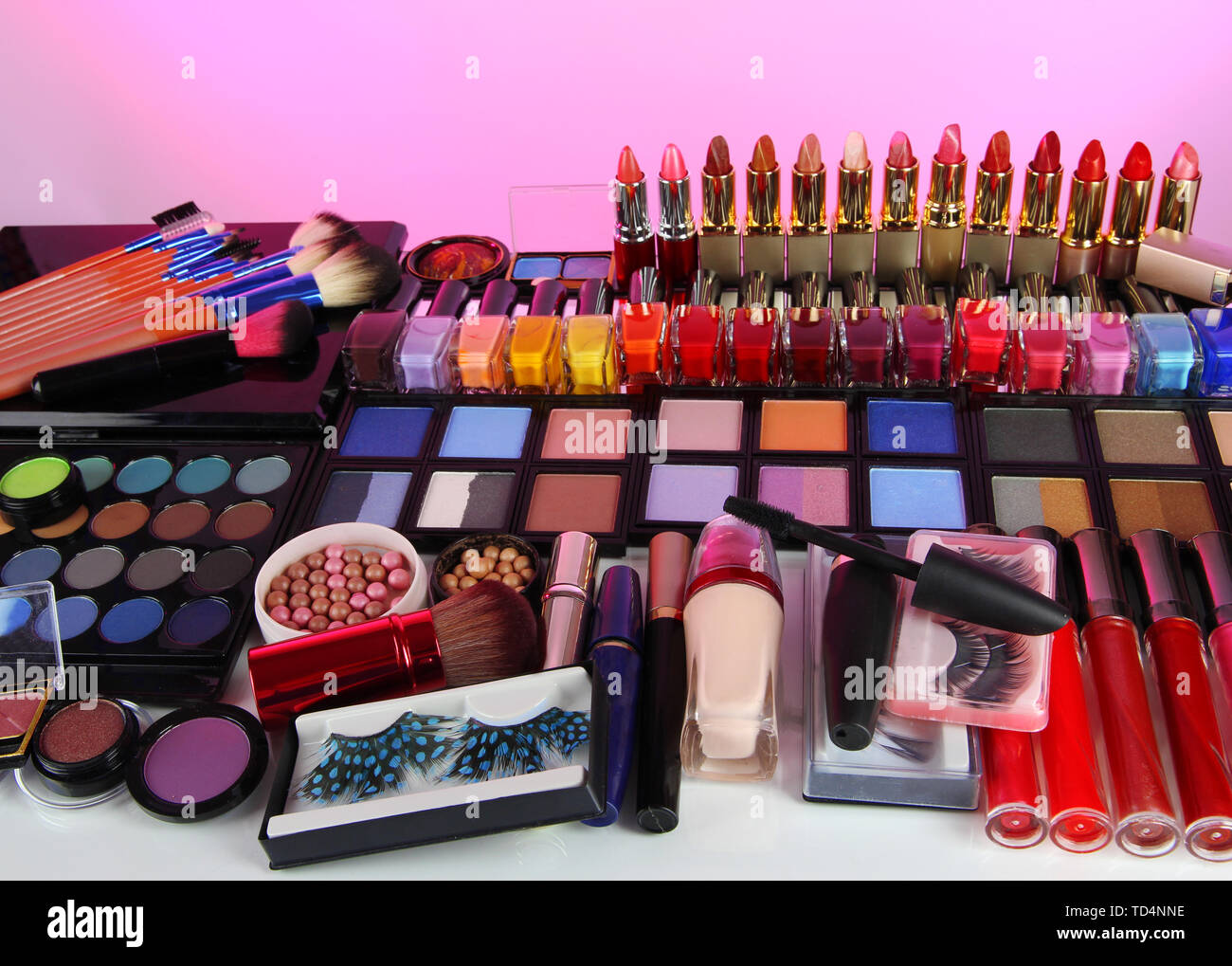 Lot of different cosmetics on pink background Stock Photo