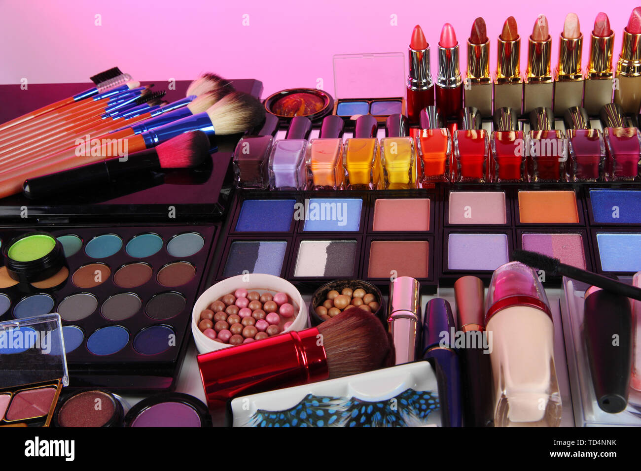 Lot of different cosmetics on pink background Stock Photo