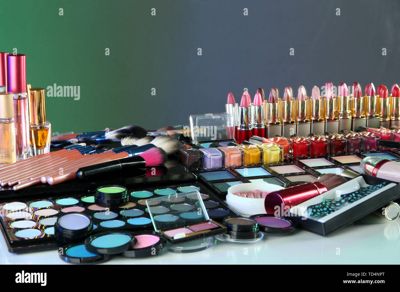 Lot of different cosmetics on green background Stock Photo