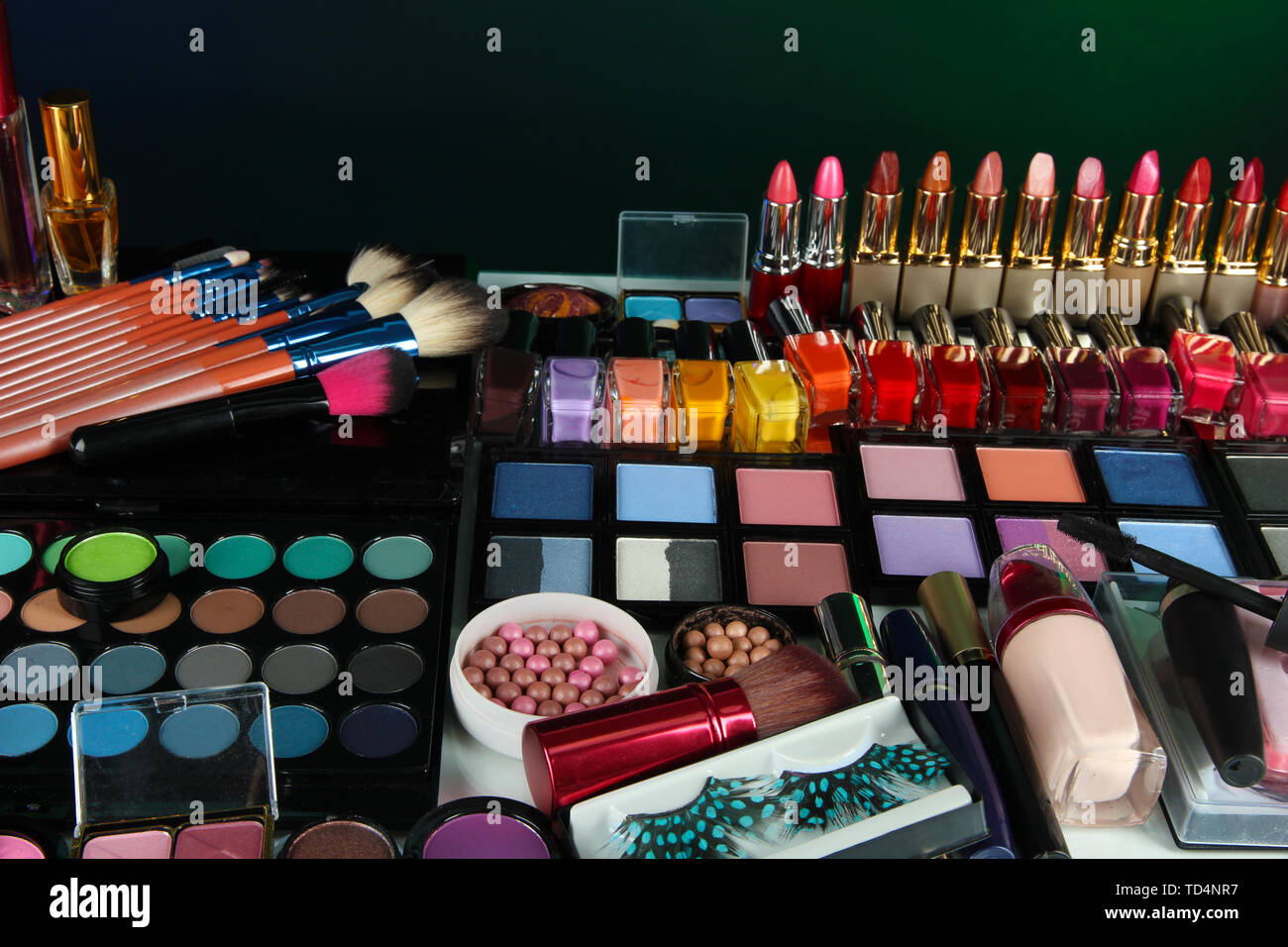 Lot of different cosmetics on green background Stock Photo
