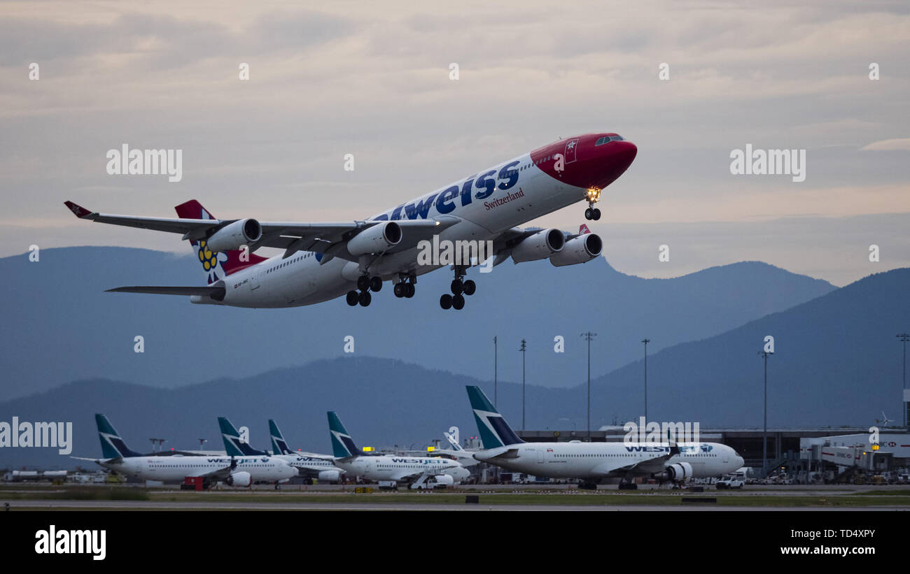 Richmond, British Columbia, Canada. 4th June, 2019. An Edelweiss Air Airbus A340-313X (HB-JMG) wide-body jet airliner airborne after take-off. The Swiss leisure airline is wholly owned by Swiss International Air Lines, part of the Lufthansa Group. Credit: Bayne Stanley/ZUMA Wire/Alamy Live News Stock Photo