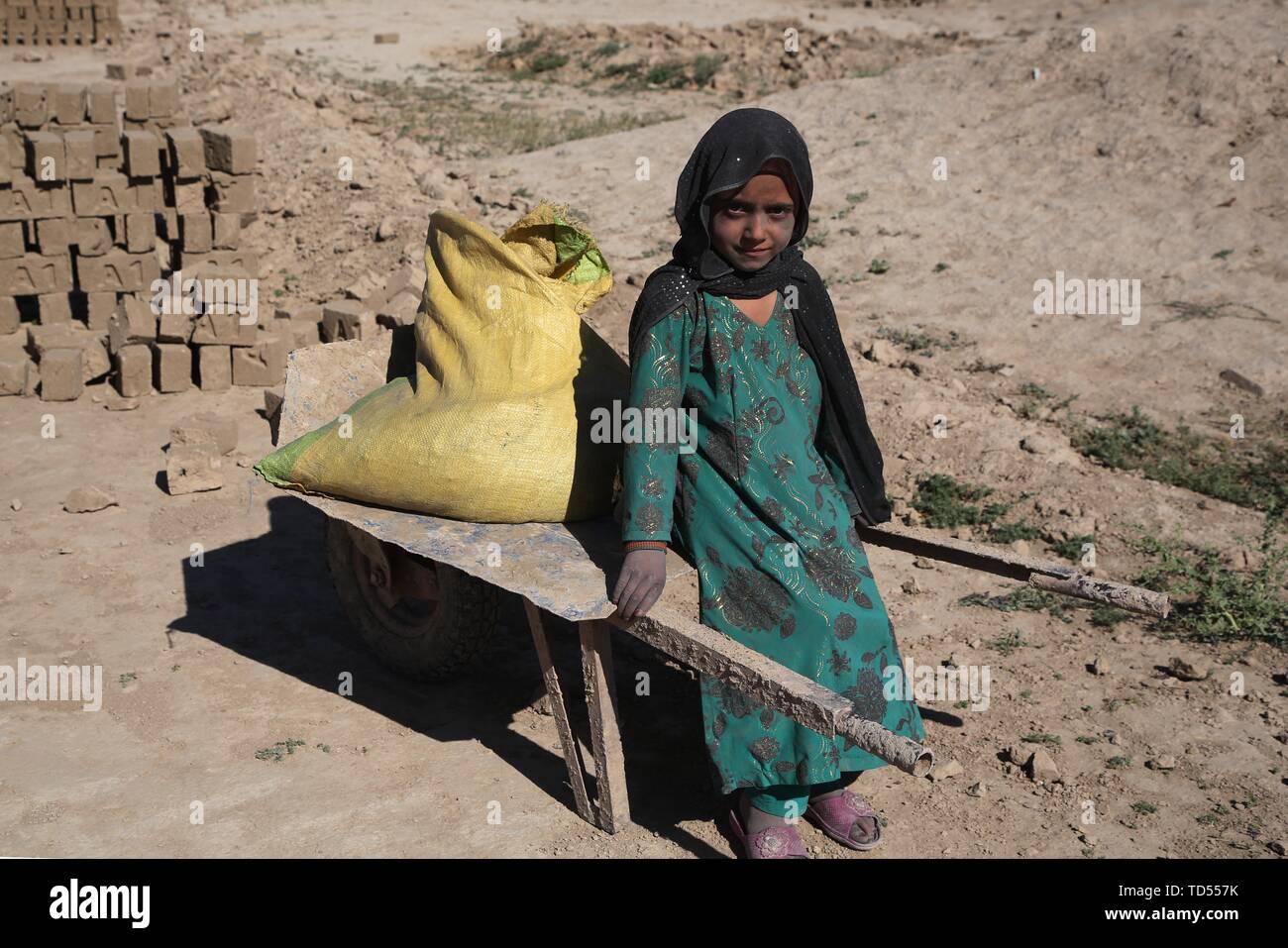 Kabul, Afghanistan. 12th June, 2019. An Afghan child works at a brick factory in Kabul, capital of Afghanistan, June 12, 2019. The decades-long war and extreme poverty have taken the toll on Afghan children, with around 30 percent of those between six and 15 years old having to work long hours to support their families, and many do not go to school. TO GO WITH 'Feature: Child labor still a worry in Afghanistan' Credit: Rahmat Alizadah/Xinhua/Alamy Live News Stock Photo