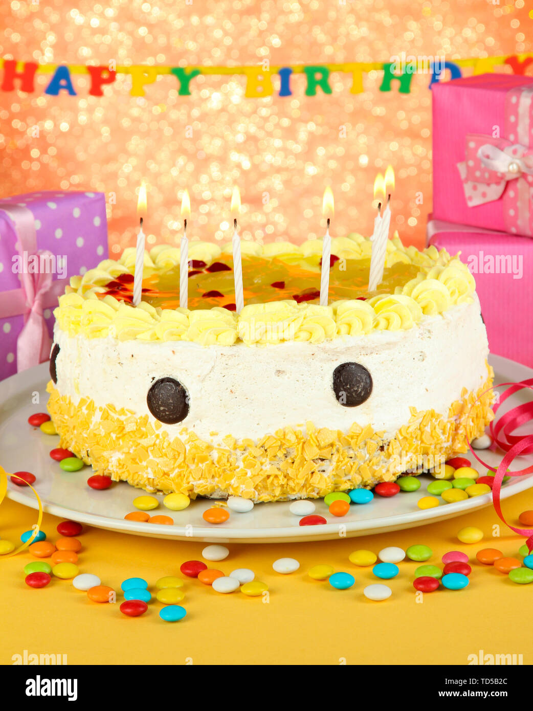 Happy birthday cake and gifts, on red background Stock Photo