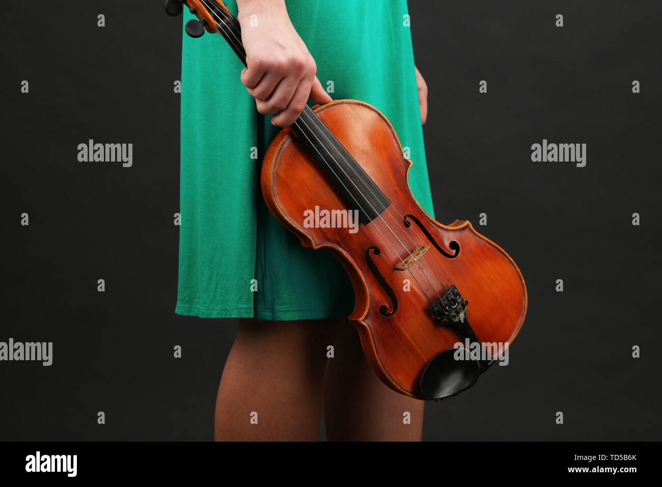 Young girl with violin on grey background Stock Photo - Alamy