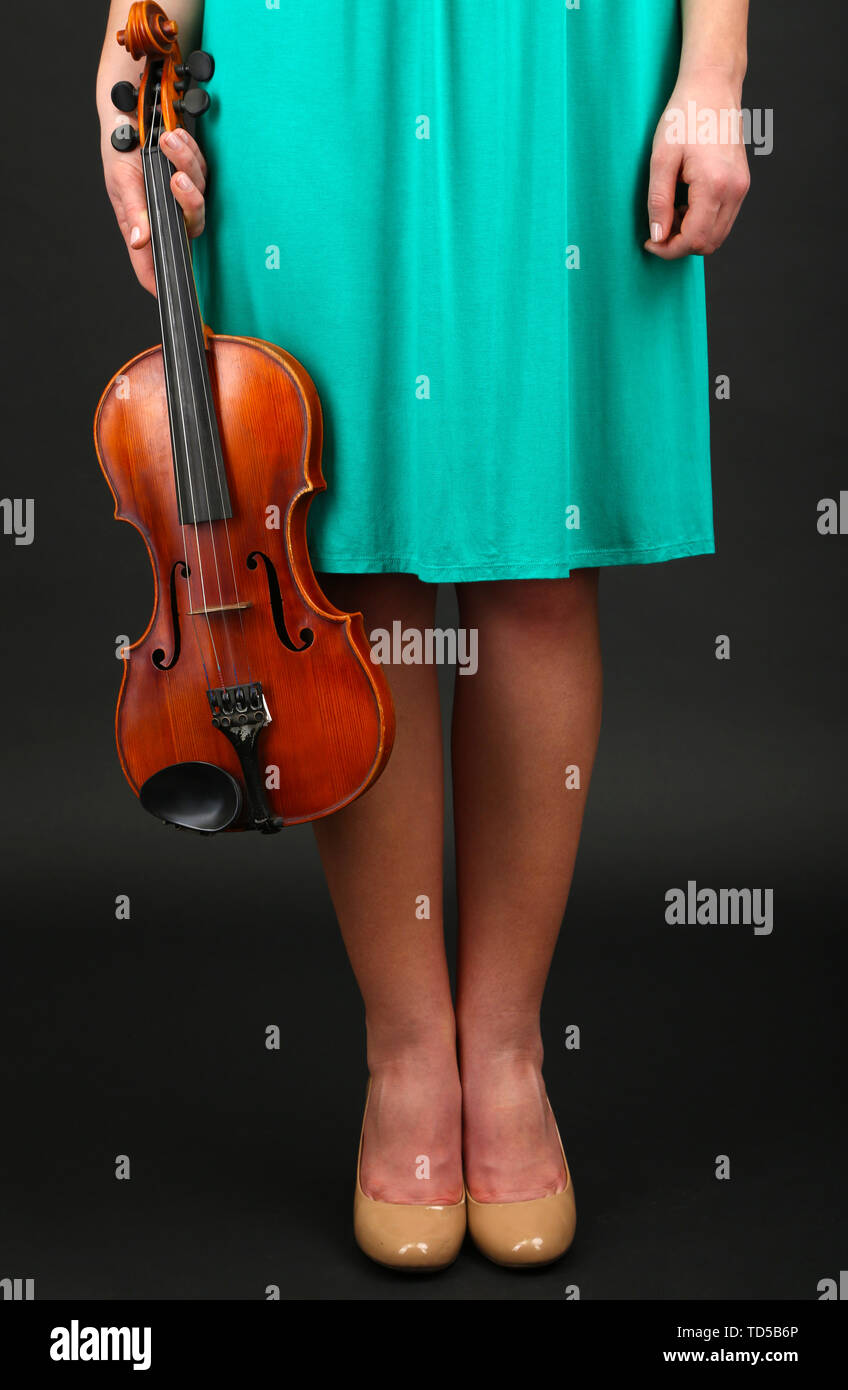 Young girl with violin on grey background Stock Photo - Alamy