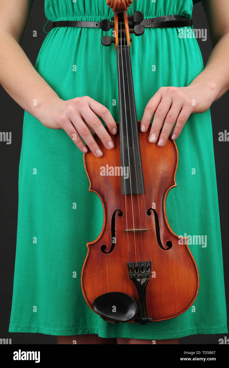 Young girl with violin on grey background Stock Photo - Alamy