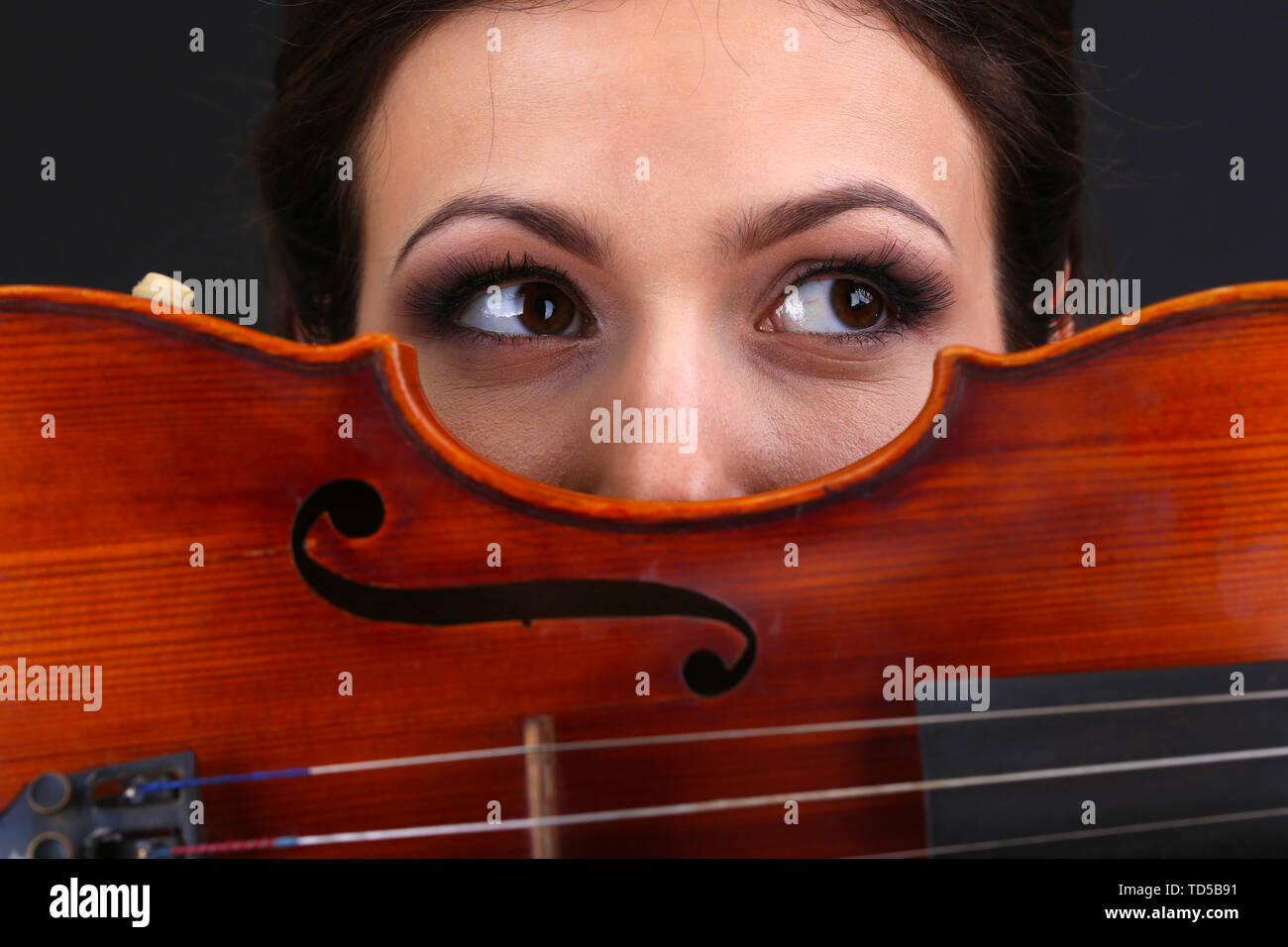Beautiful young girl with violin on grey background Stock Photo - Alamy