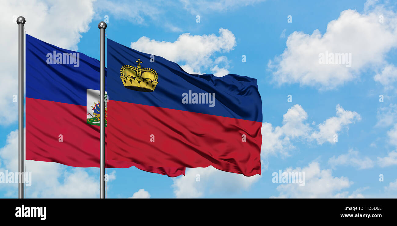 Haiti and Liechtenstein flag waving in the wind against white cloudy blue sky together