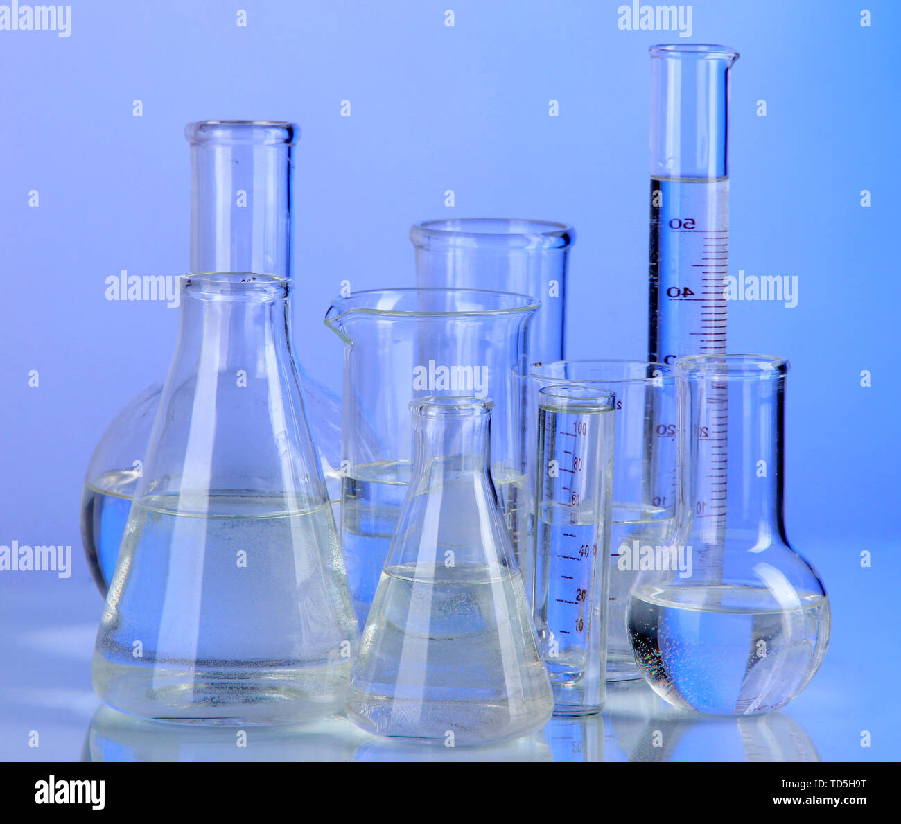 Test tubes on blue background Stock Photo - Alamy