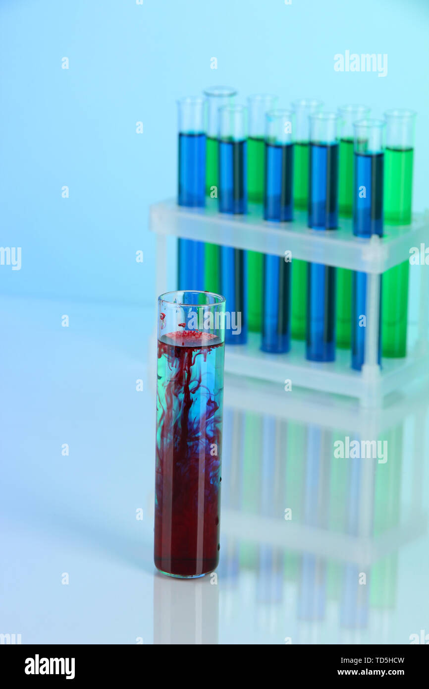 Test tubes on blue background Stock Photo - Alamy