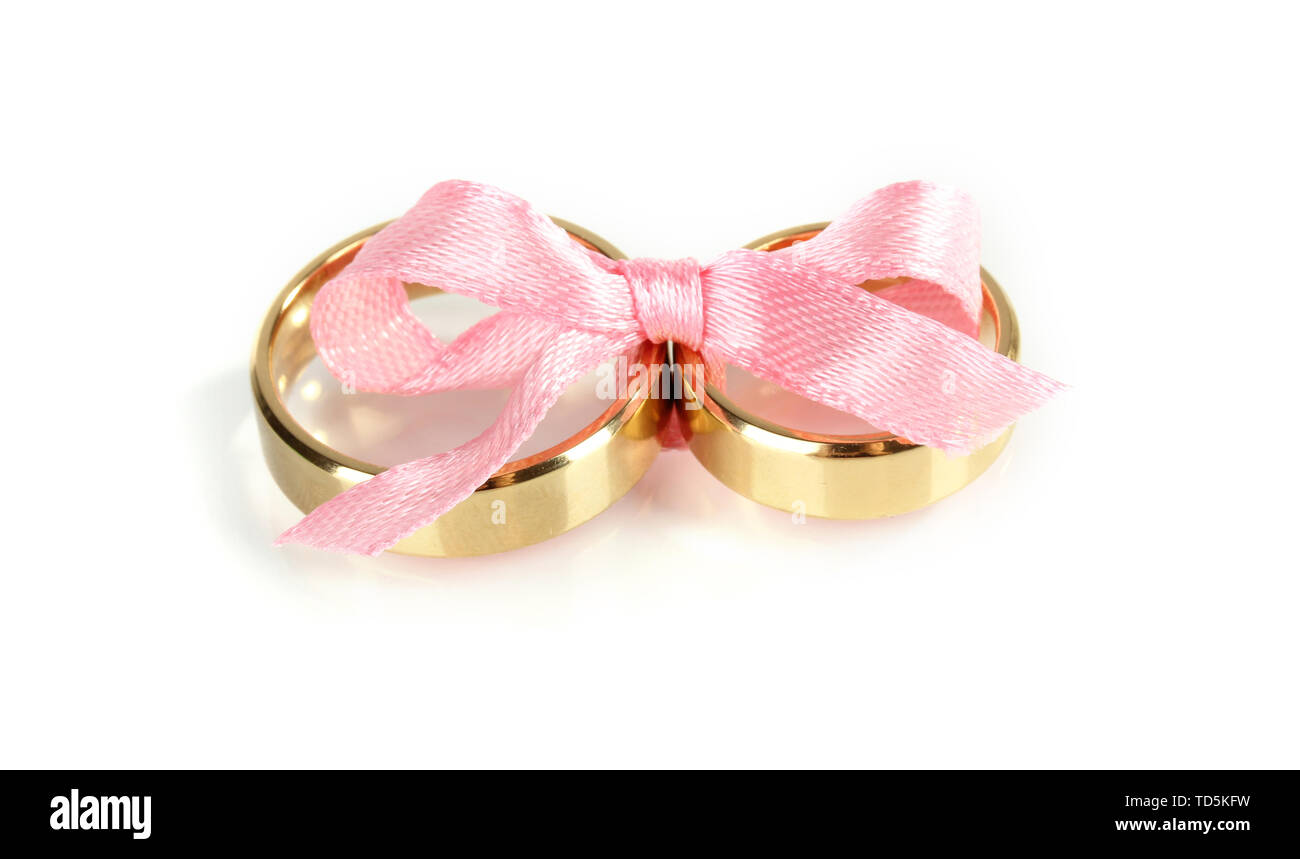 Wedding rings tied with ribbon isolated on white Stock Photo