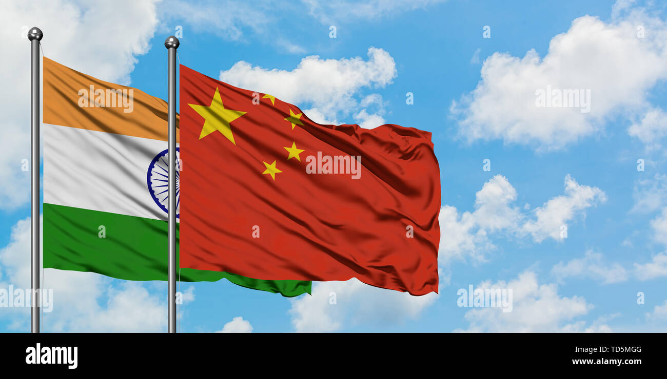 India and China flag waving in the wind against white cloudy blue sky together. Diplomacy concept, international relations. Stock Photo