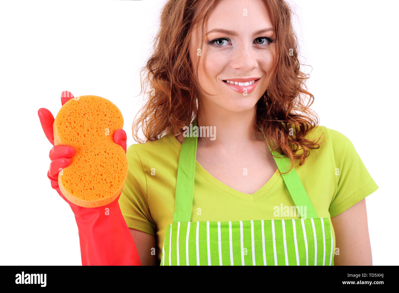 Young woman wearing green apron and rubber gloves with sponge, isolated