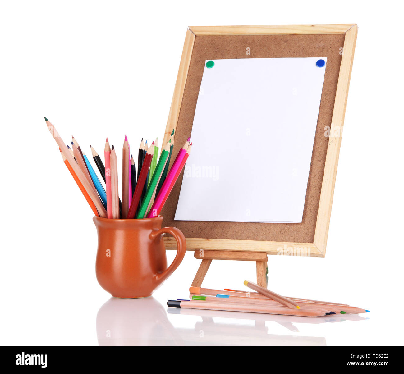 Small easel with sheet of paper with art supplies isolated on white