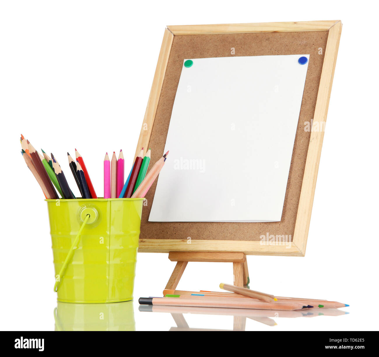 Small easel with sheet of paper with art supplies isolated on white