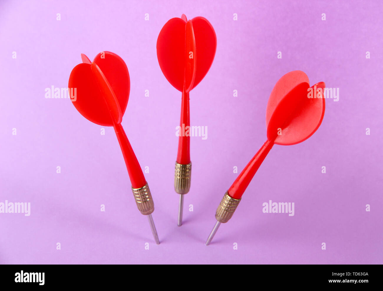 Darts on purple background Stock Photo Alamy