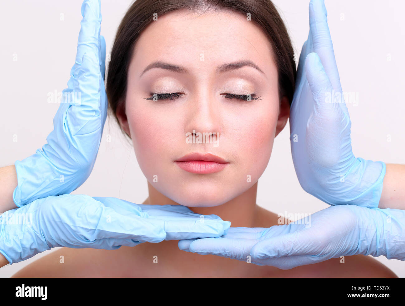 Rubber gloves touching face of young woman close up Stock Photo Alamy