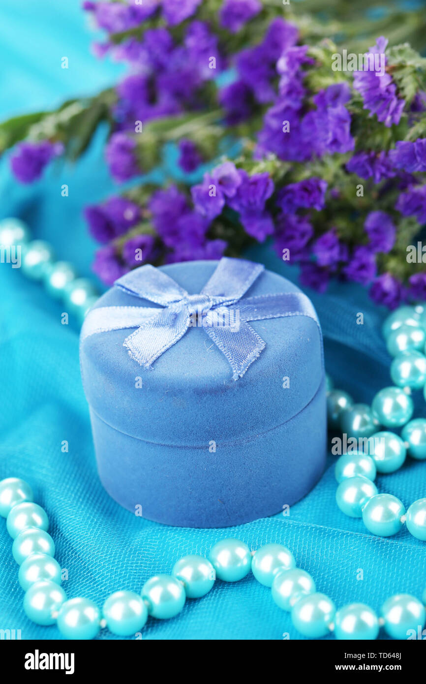 Flowers and engagement ring box on blue cloth Stock Photo Alamy
