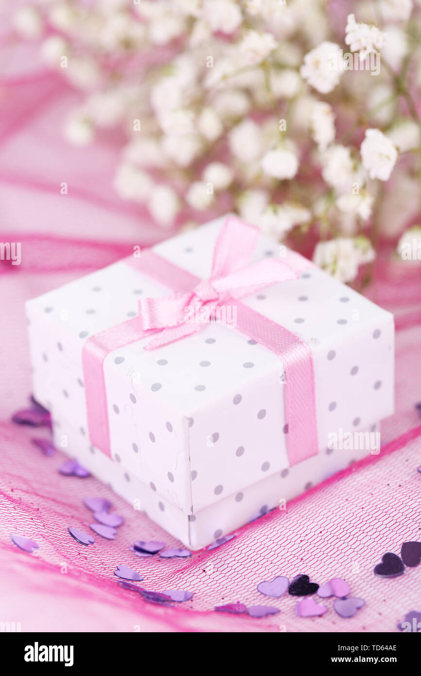 Flowers and gift box on pink background Stock Photo