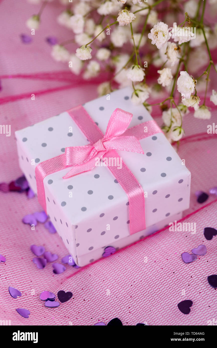 Flowers and gift box on pink background Stock Photo