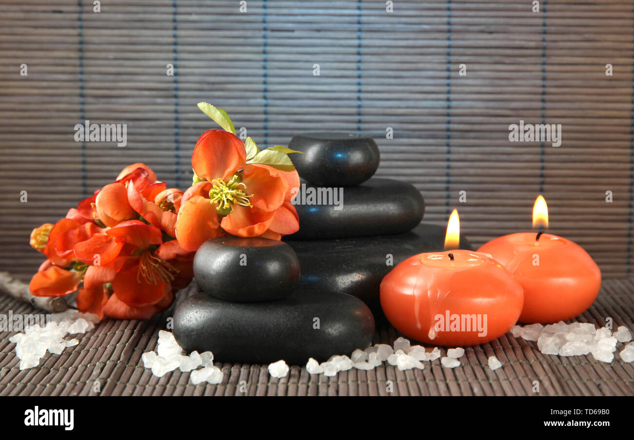Spa stones with flowers and candles on bamboo background Stock Photo ...