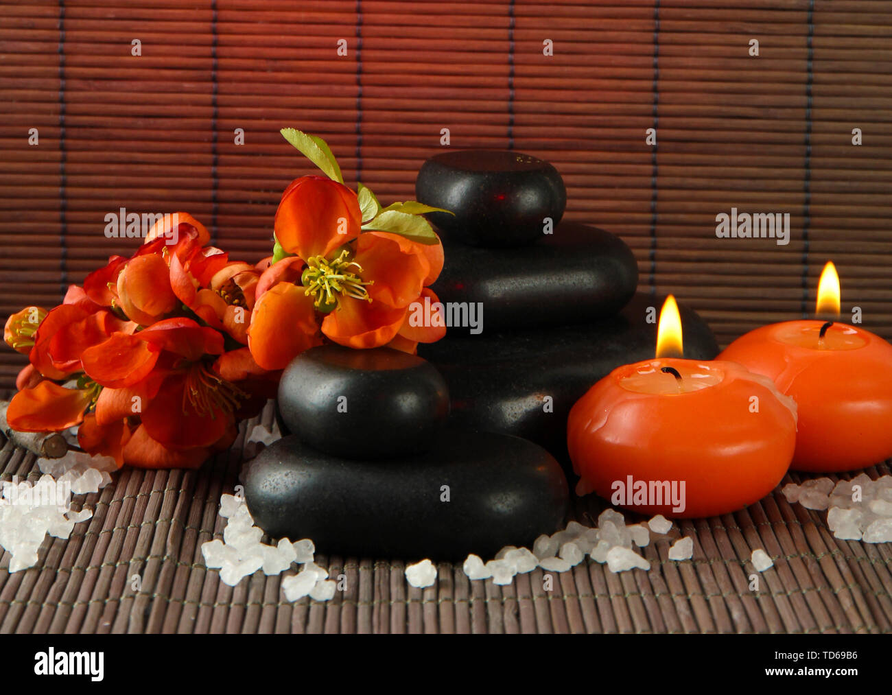 Spa stones with flowers and candles on bamboo background Stock Photo ...