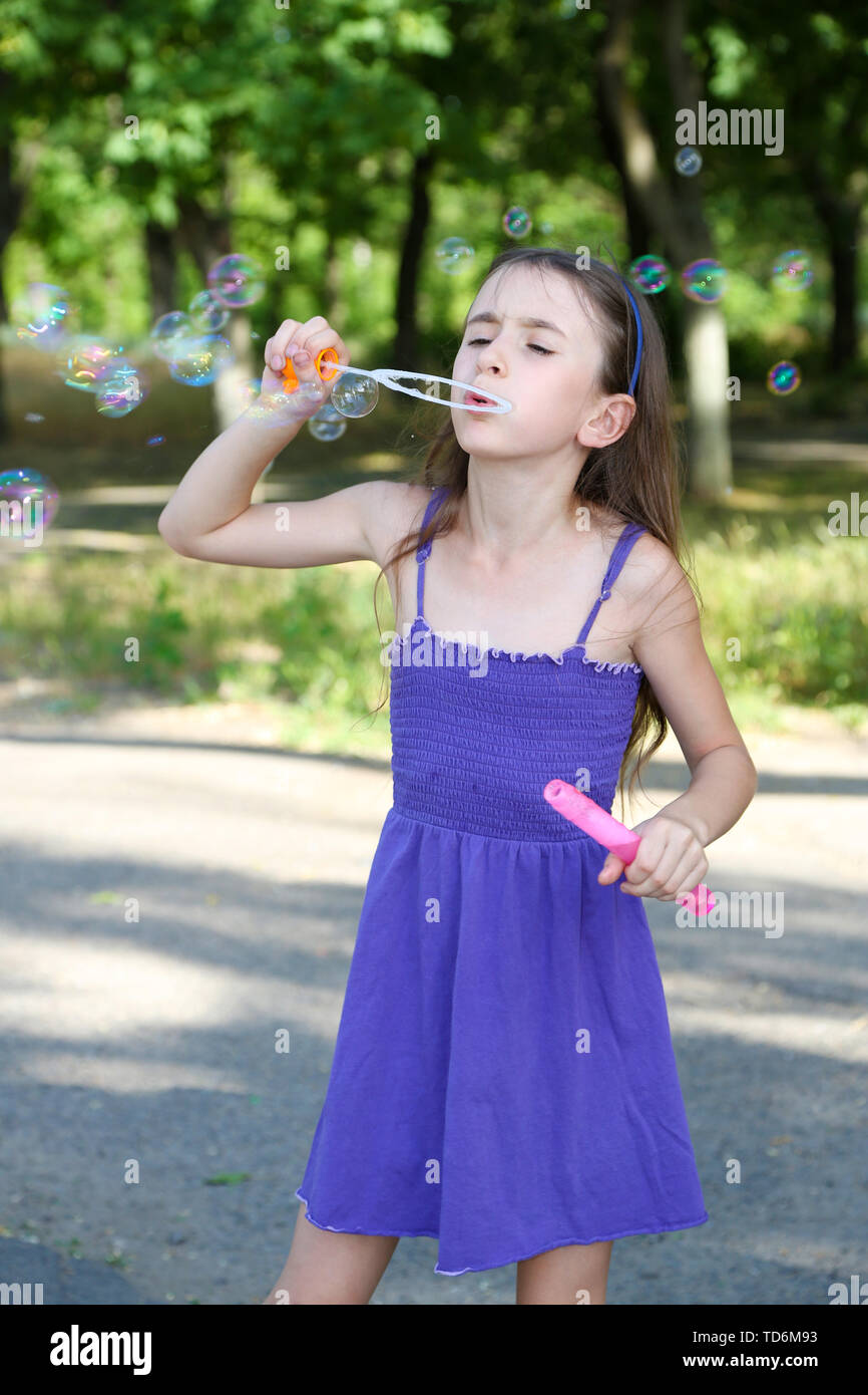 Cute girl blowing colorful hi-res stock photography and images - Alamy