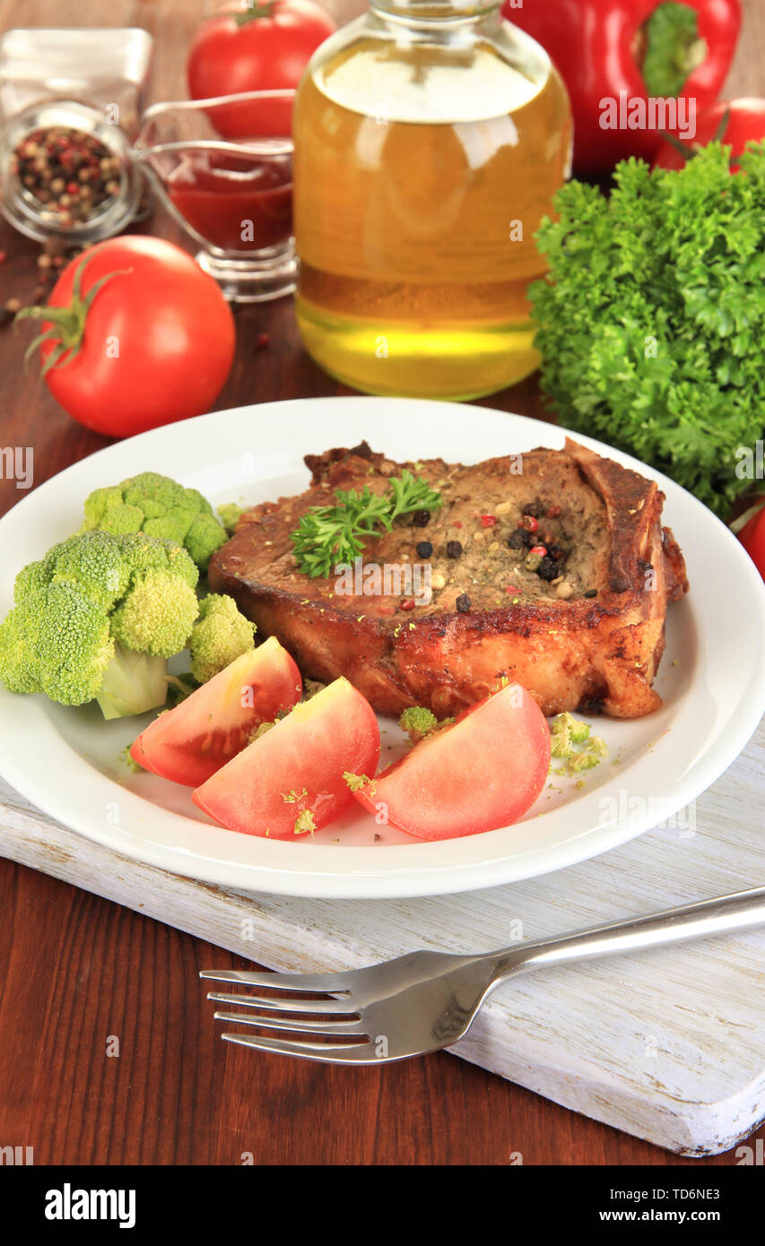 Comp Tabel Piece of fried meat on plate on wooden table close-up Stock Photo - Alamy