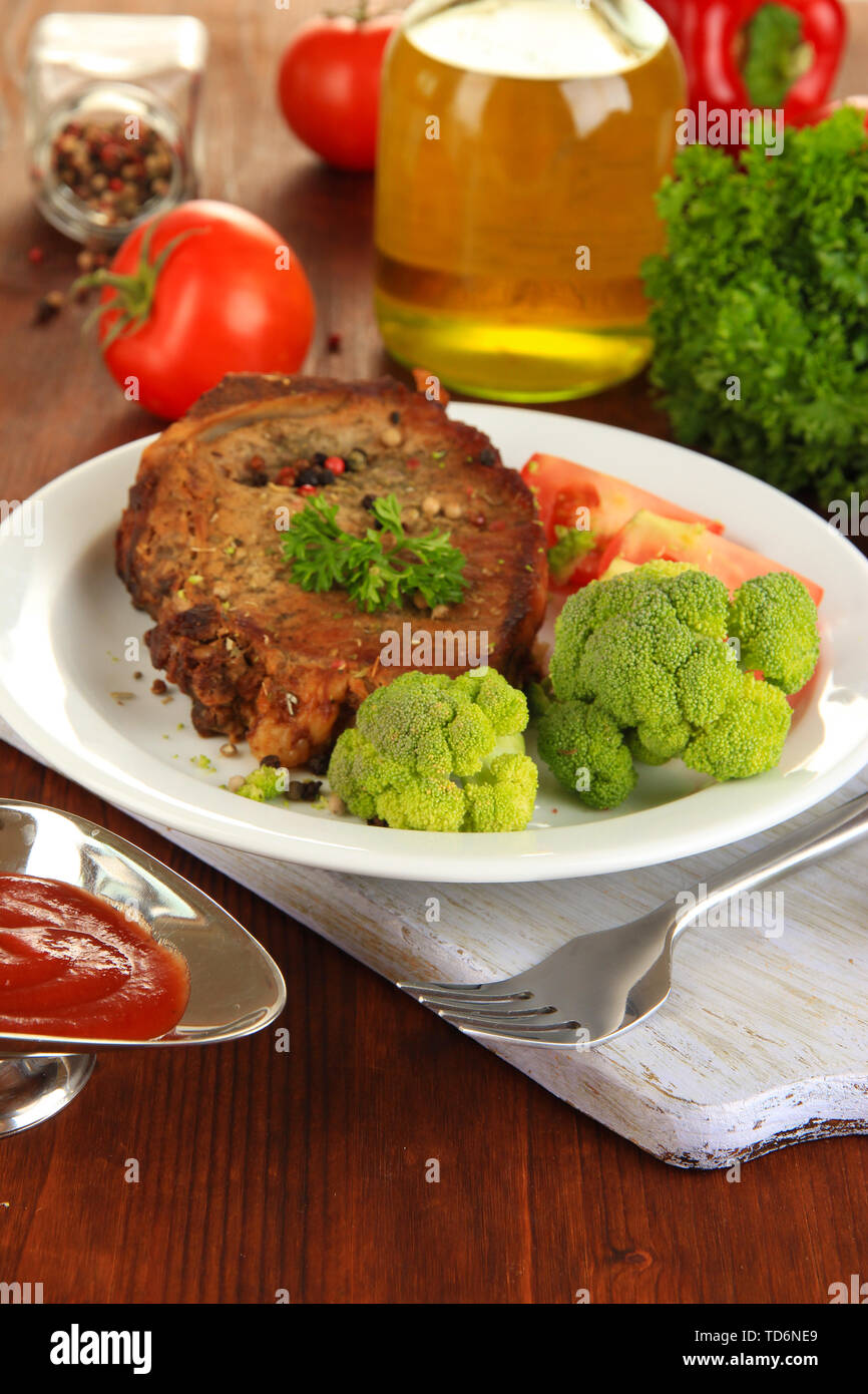 Comp Tabel Piece of fried meat on plate on wooden table close-up Stock Photo - Alamy