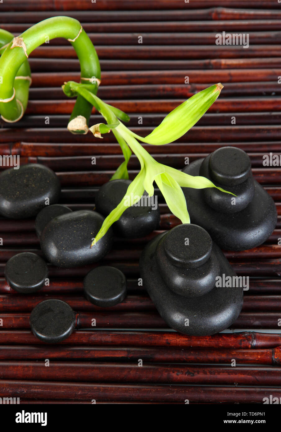 Spa stones and bamboo on bamboo mat background Stock Photo - Alamy