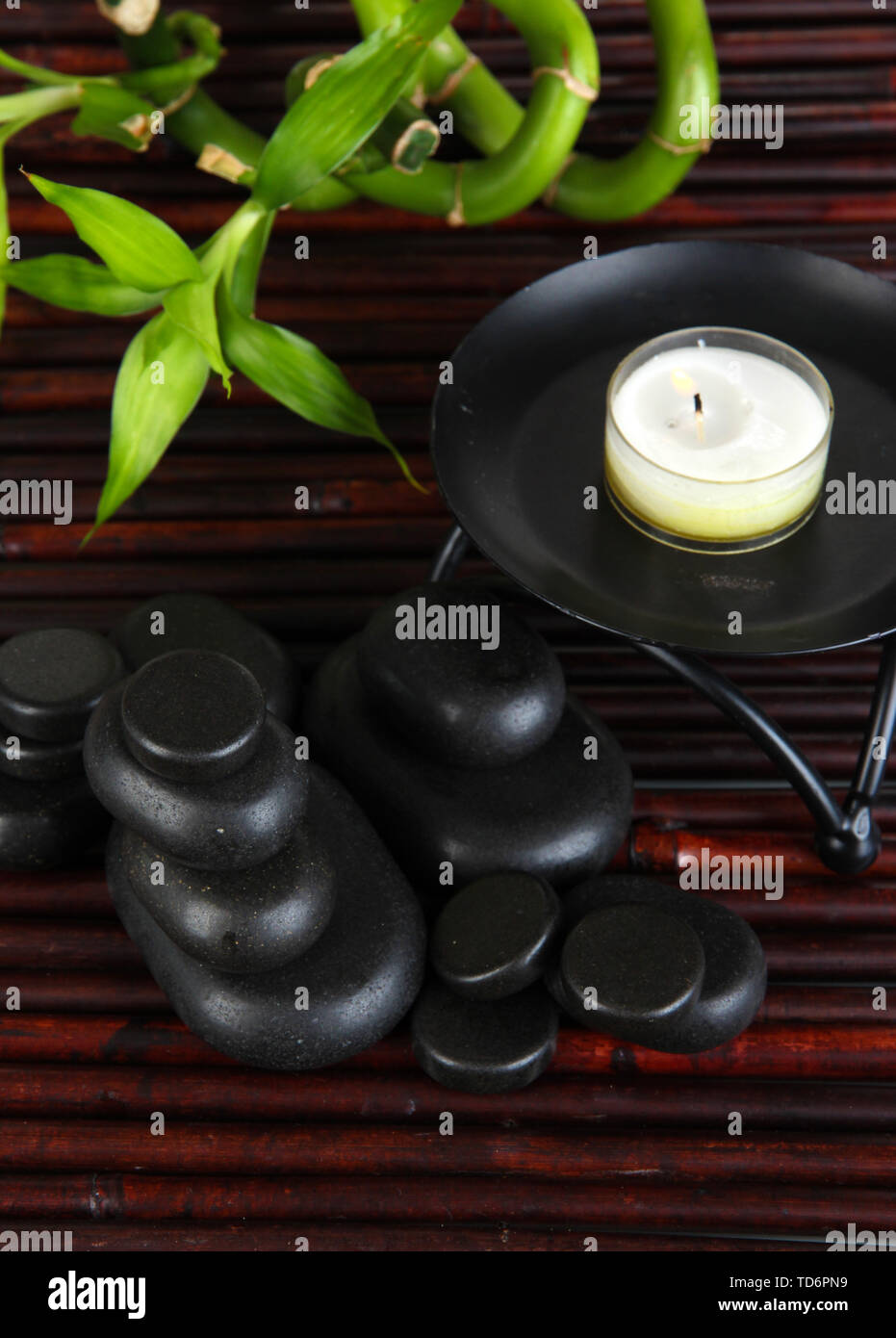 Spa stones and bamboo on bamboo mat background Stock Photo - Alamy