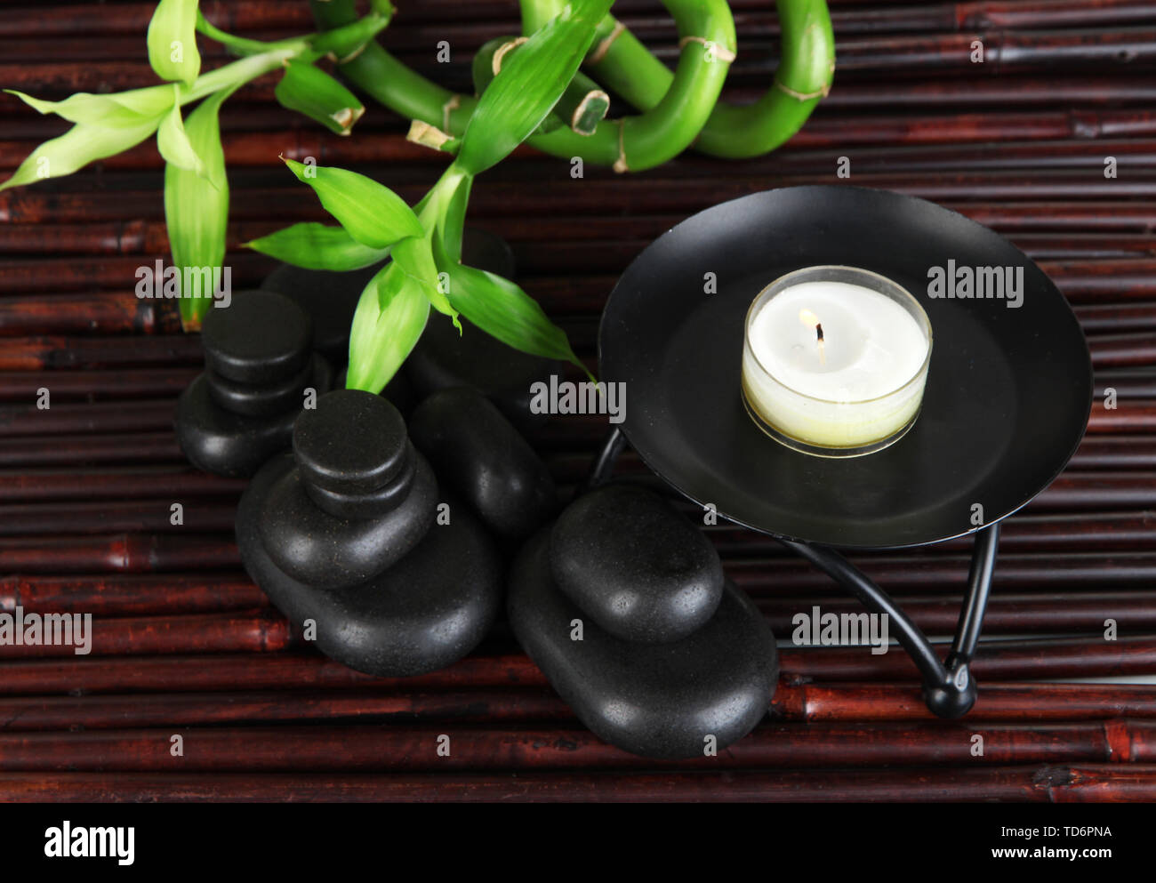 Spa stones and bamboo on bamboo mat background Stock Photo - Alamy