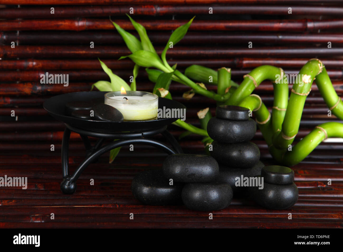 Spa stones and bamboo on bamboo mat background Stock Photo - Alamy