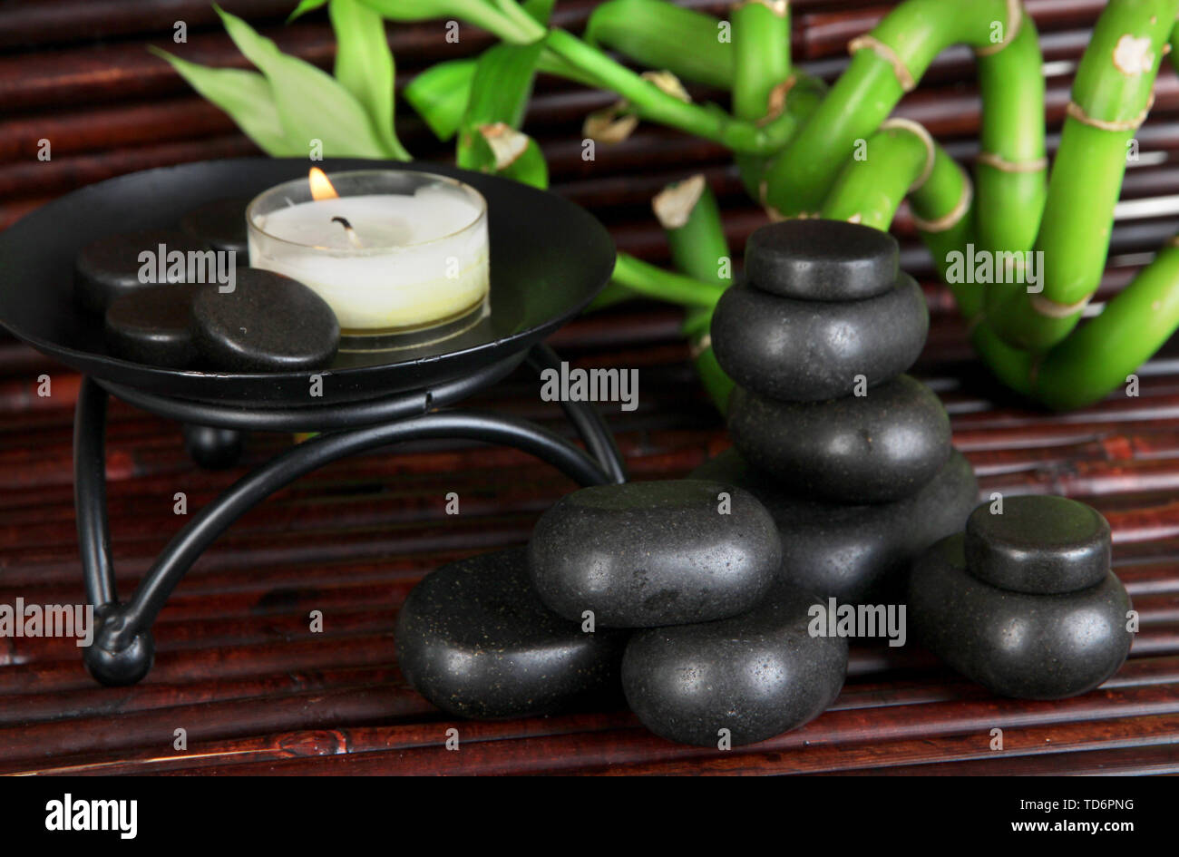 Spa stones and bamboo on bamboo mat background Stock Photo - Alamy