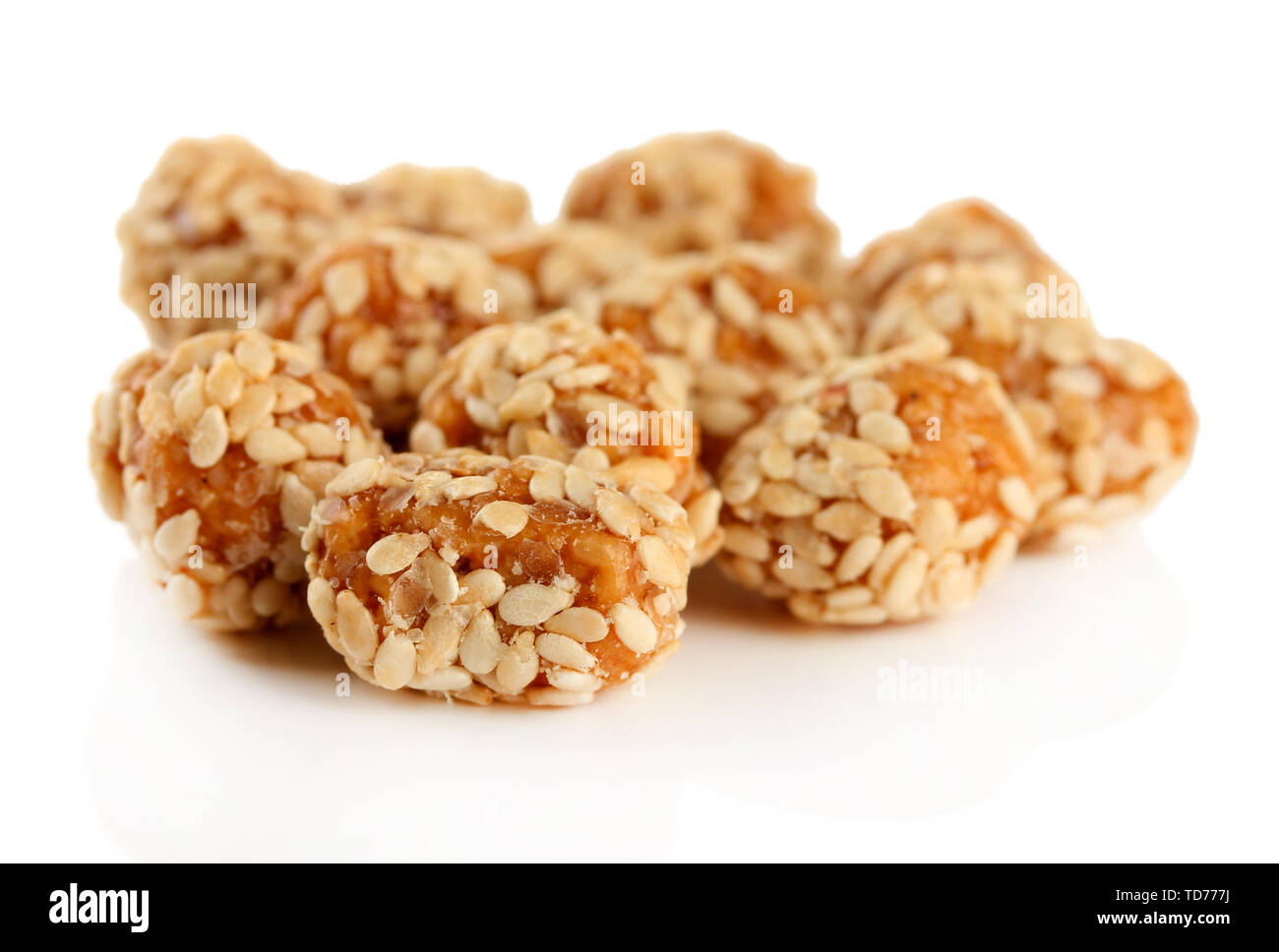 Tasty peanuts with sesame and caramel, isolated on white Stock Photo