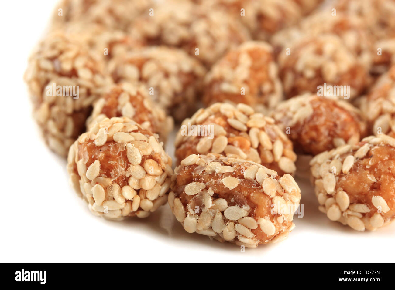 Tasty peanuts with sesame and caramel, isolated on white Stock Photo