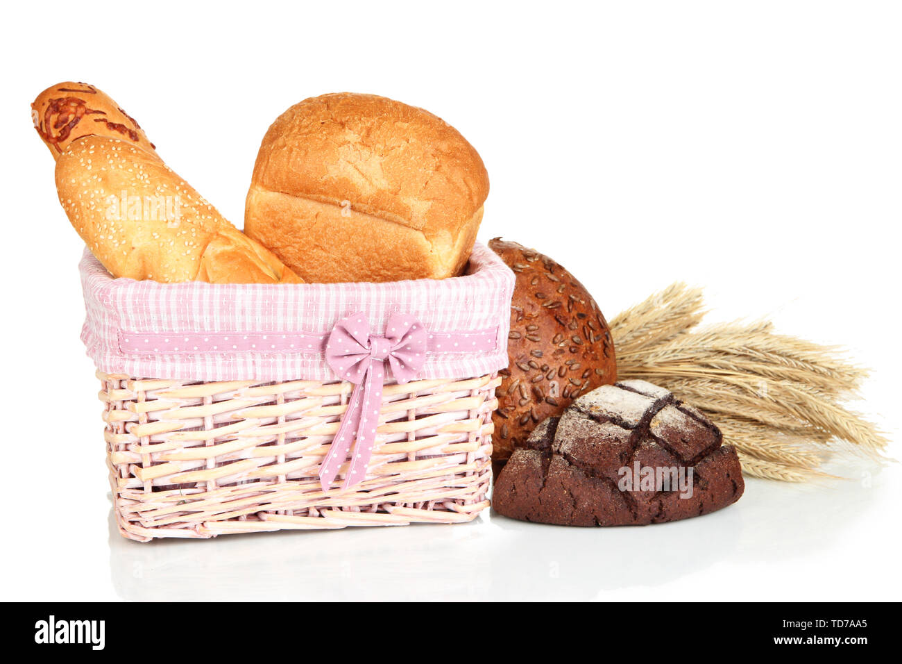 Baked bread in wicker basket isolated on white Stock Photo