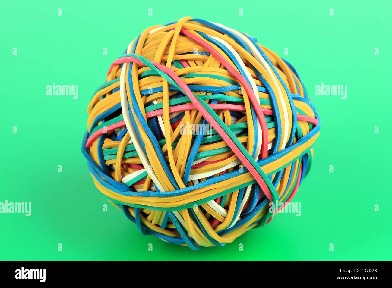 Colorful rubber bands on green background Stock Photo - Alamy