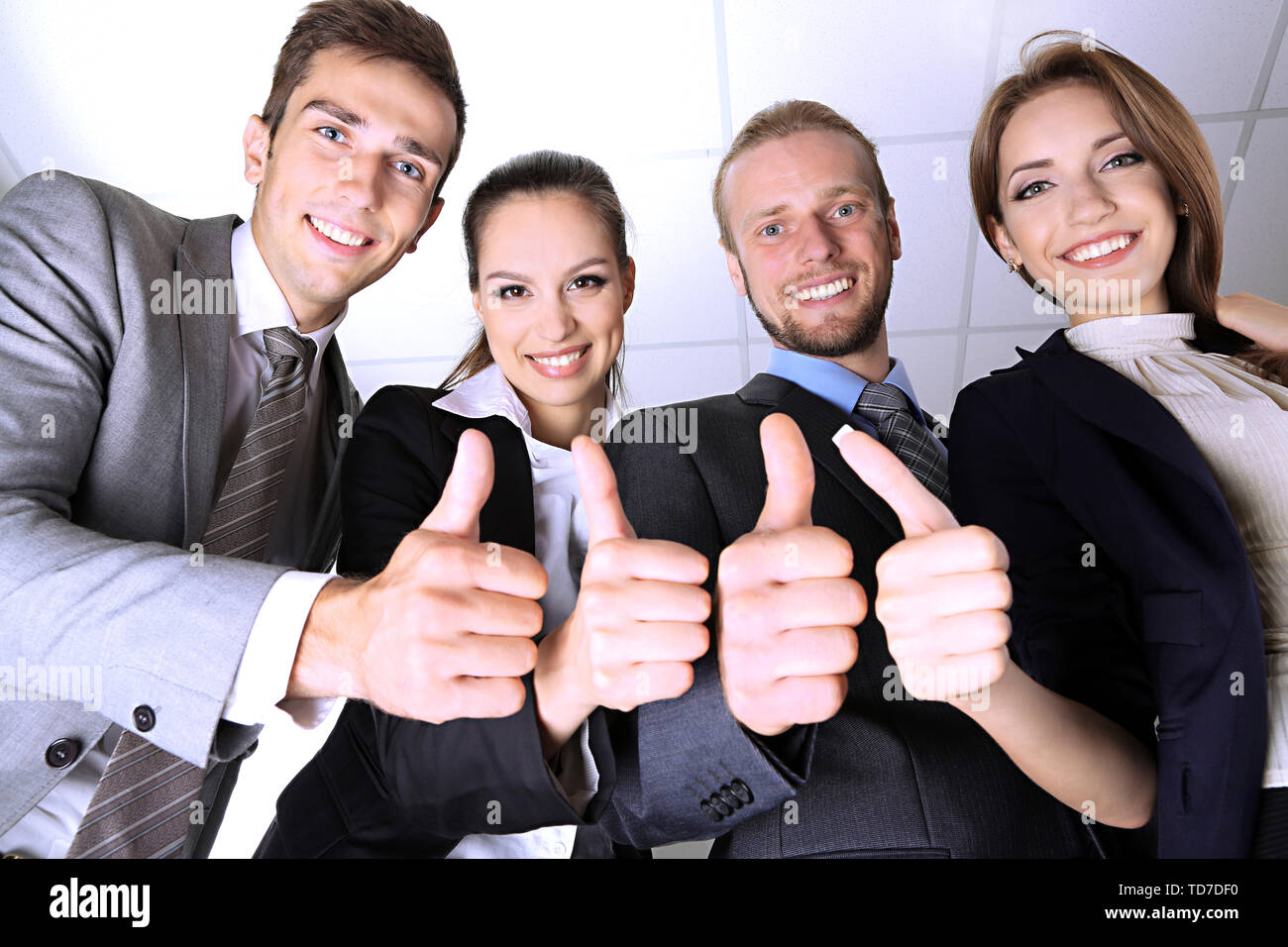 Business team showing thumbs up in office Stock Photo - Alamy