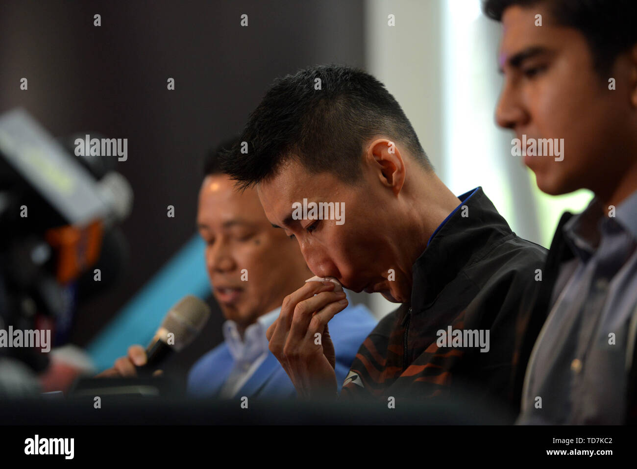 Putrajaya, Malaysia. 13th June, 2019. Malaysia's badminton player Lee Chong Wei (C) reacts during a news conference to announce his retirement in Putrajaya, Malaysia, June 13, 2019. Credit: Chong Voon Chung/Xinhua/Alamy Live News Stock Photo