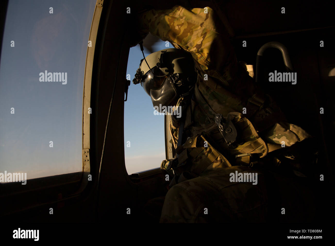 Dahlke, Afghanistan. 17th Oct, 2018. A Crew Chief, the pilot's eyes for the side of the helicopter, keeps watch out of a Blackhawk UH-60 during dusk.FOB(forward operating base) Dahlke is a new austere US Army base, as of Spring 2018, in Afghanistan that began with a large presence of soldiers from the 101st Combat Aviation Brigade. Dahlke is strategically located about 60 miles South of Kabul. Every type of air support mission is done from here, from medevac to resupply to combat. Dahlke was built from the ground up over the past year by the soldiers stationed here. It is built on the So Stock Photo